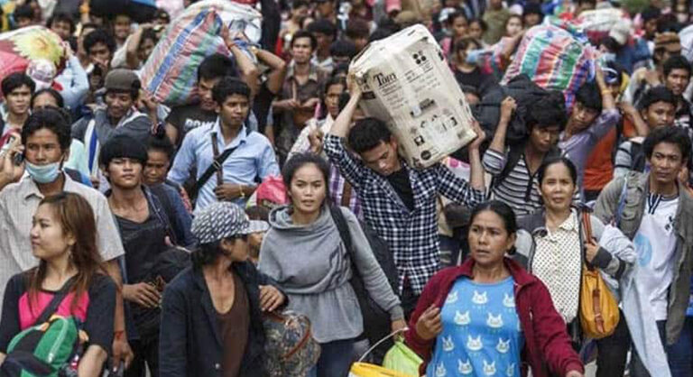 A képen rengeteg ázsiai vendégmunkás látható, miközben nagy csomagokkal utaznak.