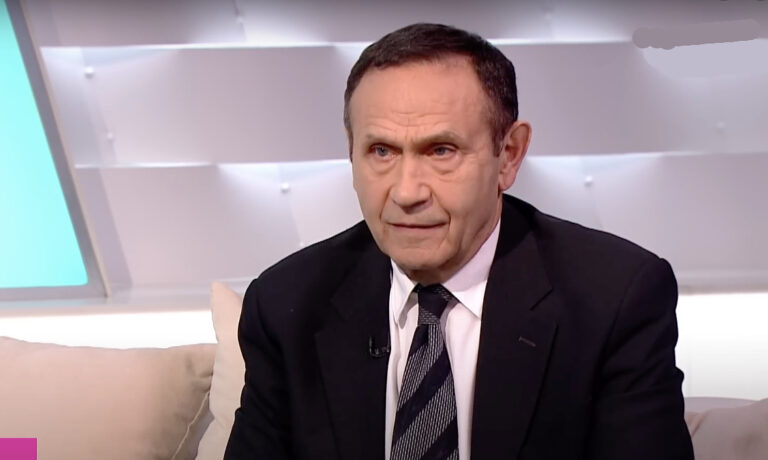Gyárfás Tamás az ATV stúdiójában interjút ad egy drapp kanapén nyakkendőben és feket zakóban, fehér ingben