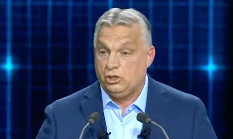 Orbán Viktor sötétkék zakóban, világoskék ingben, ősz hajjal, ráncos homlokkal beszél.